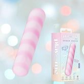 The Play With Me Sugar Crush - Pink by Blush Novelties, a pink and white striped cylindrical toy, is shown beside its pastel packaging with playful designs and product info, set against a soft bokeh background.
